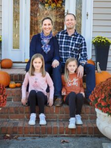 Family of four sits on steps